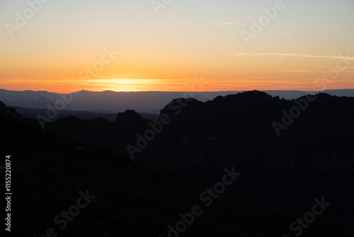 Atardecer entre las montañas con tonos naranjas