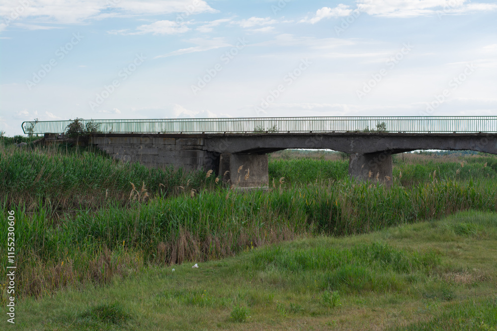 Reinforced concrete road bridge over the river. Close-up during sunny day in summer Reinforced concrete road bridge over the river. Close-up during sunny day in summer