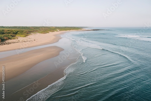 A serene coastal landscape with a sandy beach stretching along the coastline