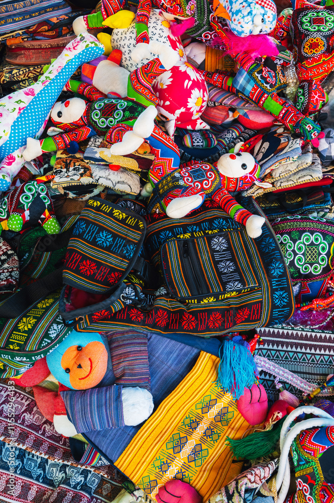 Fototapeta premium Colorful bags and various textiles on the counter at the market in Vietnam in Asia