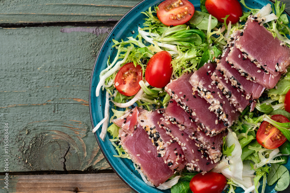 Salad with raw tuna , sesame and cherry tomatoes photography . Top view Salad with raw tuna , sesame and cherry tomatoes photography . Top view