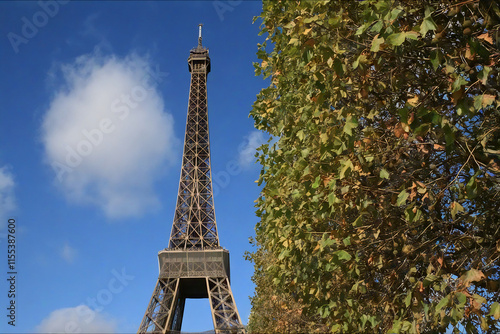 Fragment of the Eiffel Tower against the background of blue sky with clouds