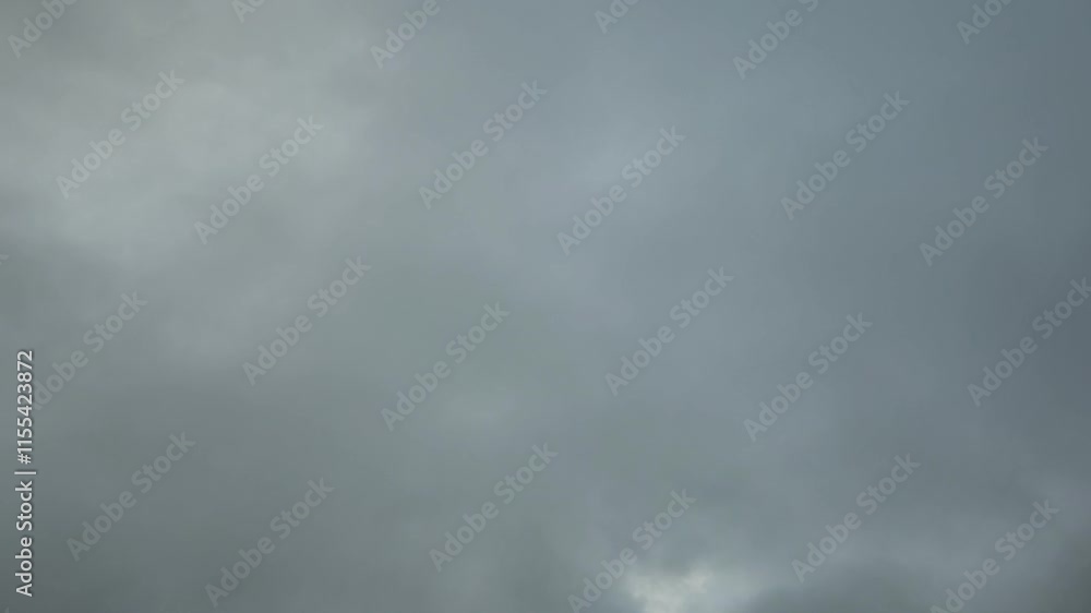 Light or orange stratocumulus cloud moving across the sky in the early morning Light or orange stratocumulus cloud moving across the sky in the early morning