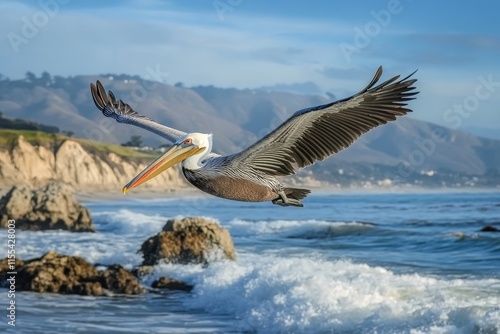 A pelican with large wings stretches gracefully as it glides over the ocean waves near rocky shores, showcasing the majesty of avian flight and coastal scenery. photo