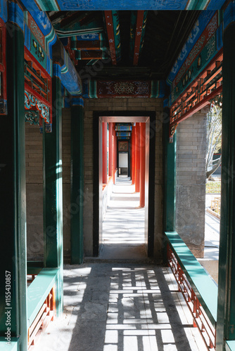 Traditional Chinese architecture with vibrant red pillars and intricate roof details photo