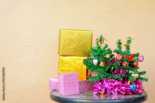 Small Christmas Tree with Decorative line and Gift Boxes on Table