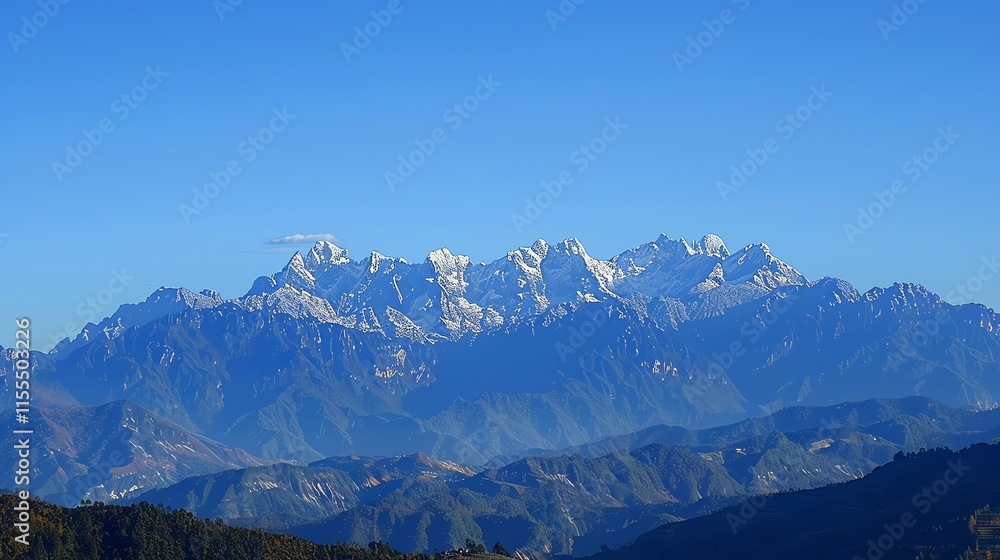 Fototapeta premium A panoramic view of snow-capped mountains against a clear blue sky.