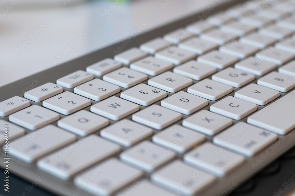 Close-up of a white computer keyboard in background Close-up of a white computer keyboard in background