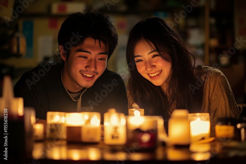 Young couple enjoying intimate dinner under warm string lights at cozy outdoo...