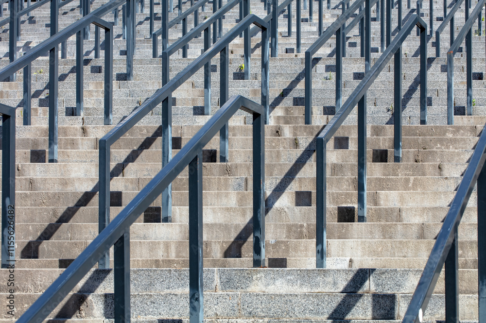 Steps leading upward gracefully in bright sunlight amidst urban architecture