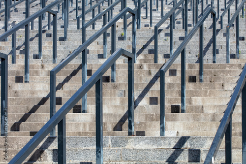 Obraz na płótnie Steps leading upward gracefully in bright sunlight amidst urban architecture w salonie