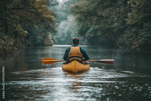 Canoeing through a tranquil river surrounded by autumn foliage and misty moun...