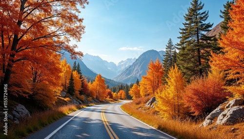 Scenic autumn road winding through vibrant orange trees and majestic mountains
