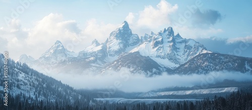 Wallpaper Mural Majestic mountain range shrouded in mist with snow-capped peaks against a serene sky landscape in tranquil natural setting. Torontodigital.ca