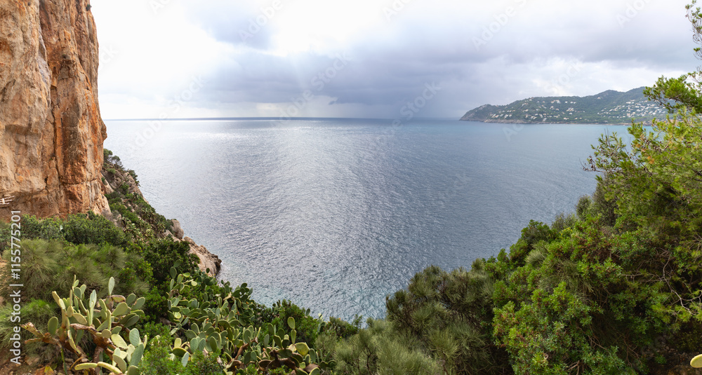 Canyamel, Mallorca, Spain (10/25/2021) - Mediterranean coastal vista with native vegetation and approaching storm clouds