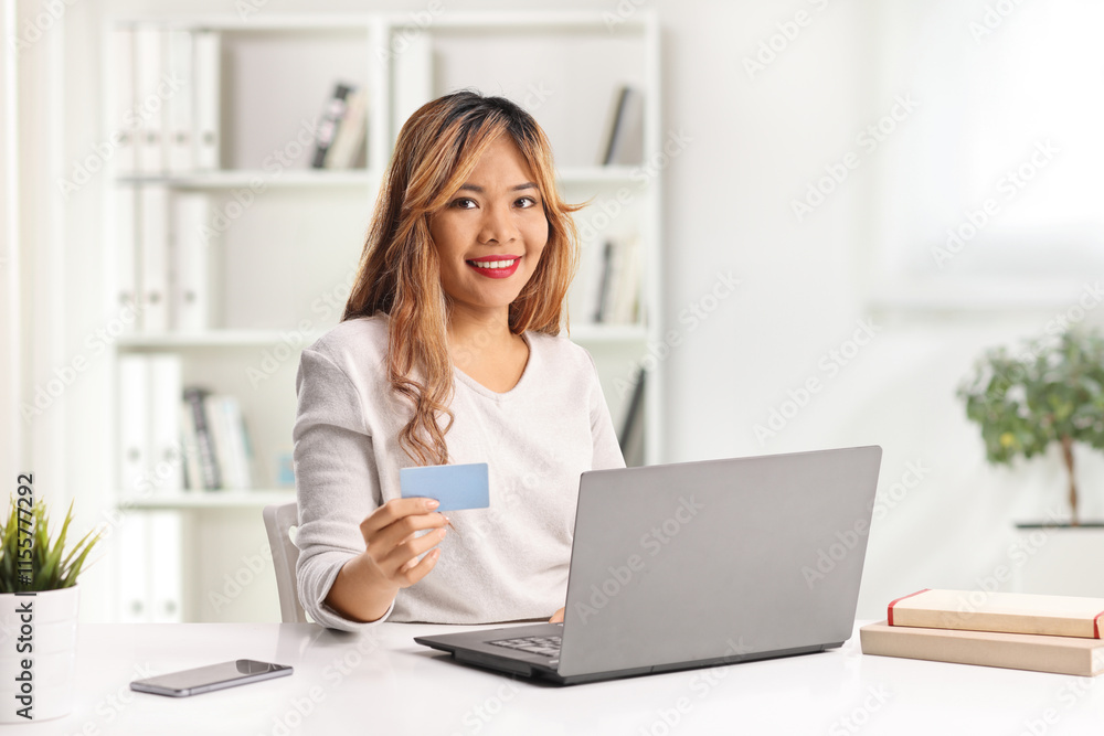 Asian woman shopping online with a laptop computer Asian woman shopping online with a laptop computer
