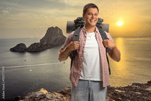 Tourist with a backpack standing on a cliff across Es Vedra photo