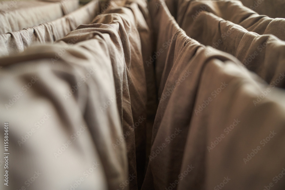 Obraz premium Close up of brown fabric folds creating abstract pattern with soft lighting.