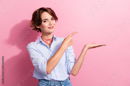 Photo of stunning nice person indicate finger hand hold empty space offer isolated on pink color background