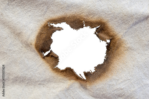 torn old white rag with burn holes on a black background photo