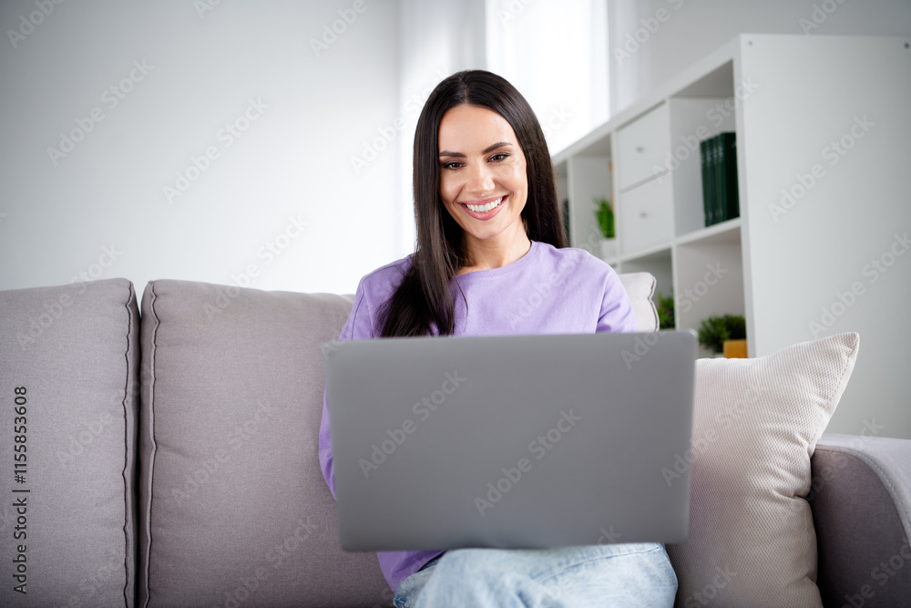 Young woman in stylish pullover enjoying leisure time at home in a cozy living room Young woman in stylish pullover enjoying leisure time at home in a cozy living room
