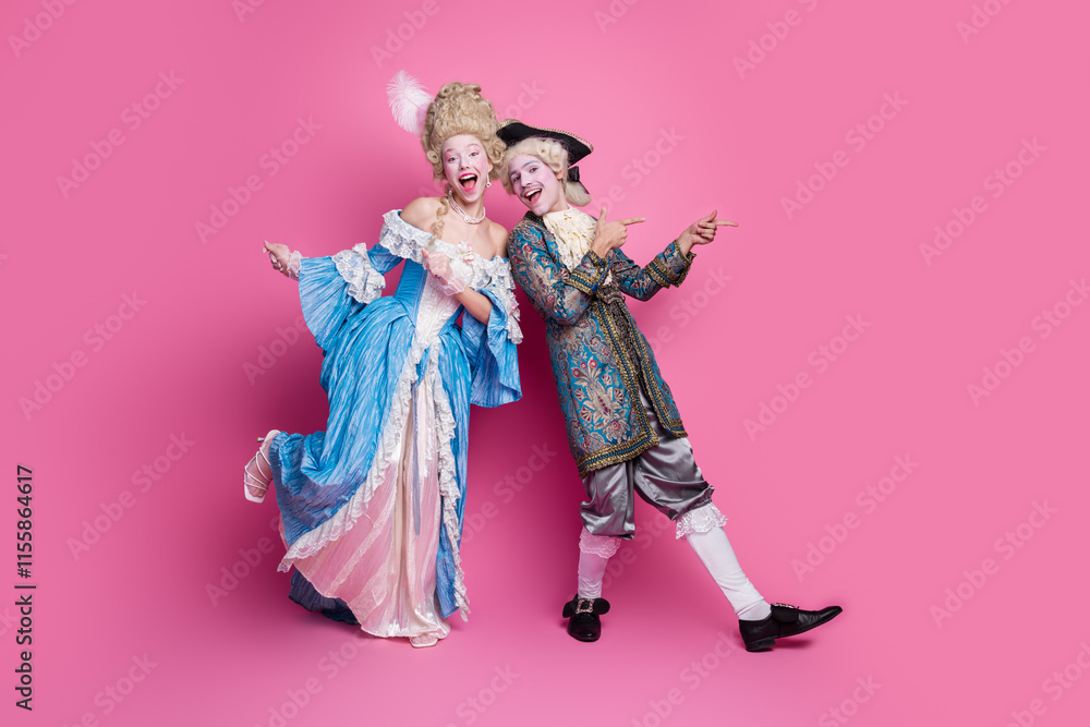 Fototapeta premium Elegant couple in vintage baroque costumes having fun against pink background, embracing classic style and fashion