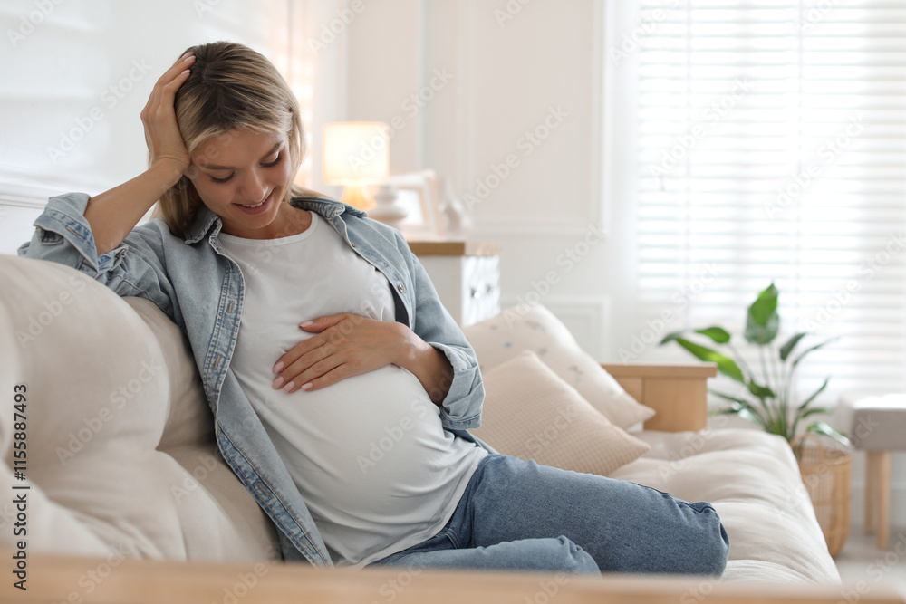 Portrait of beautiful pregnant woman on sofa at home Portrait of beautiful pregnant woman on sofa at home