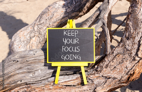 Keep your focus going symbol. Concept words Keep your focus going on beautiful black blackboard. Beautiful old tree background. Business and keep your focus going concept. Copy space photo