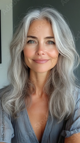 Smiling woman with silver hair and natural beauty in a bright indoor setting