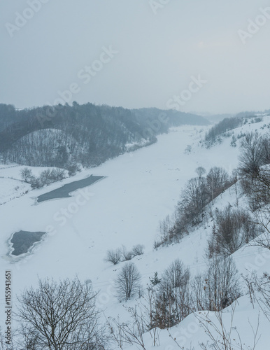 Walk over the river Sluch in the snowfall. photo