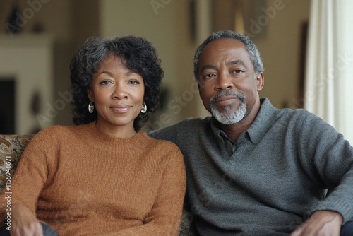 Mature couple relaxing together in cozy living room during winter afternoon