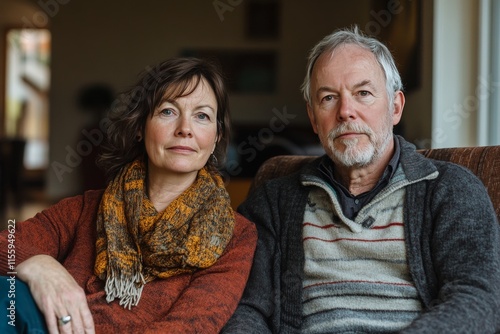 Mature couple relaxing together in cozy living room during winter afternoon