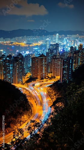 City skyline illuminated at night with busy highways and bright building ligh...