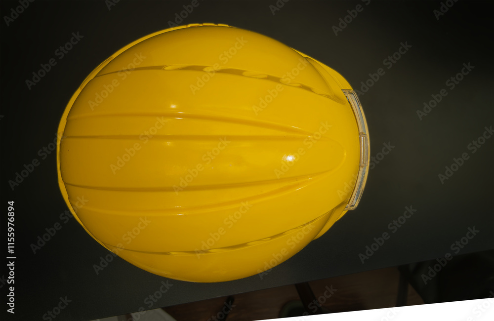 Yellow protective helmet providing safety in industrial environments