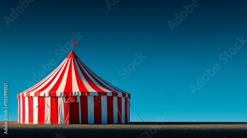 Colorful circus tent stands under a clear blue sky during daylight hours