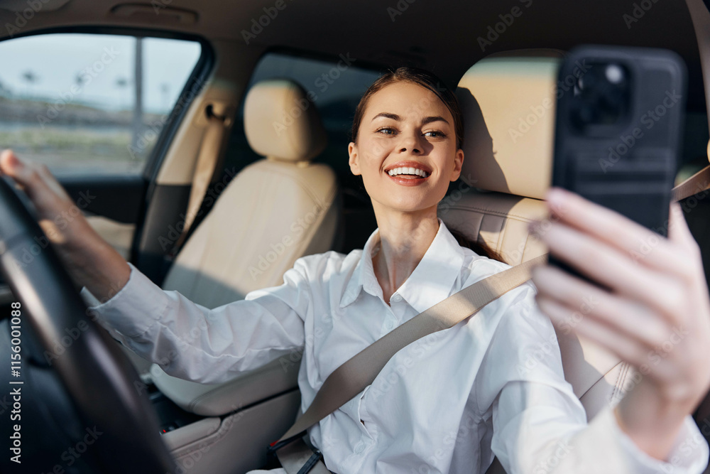 Woman, car, selfie, driving a woman is in the driver seat, taking a selfie with her phone while steering the car with one hand Woman, car, selfie, driving a woman is in the driver seat, taking a selfie with her phone while steering the car with one hand