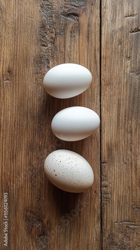 Natural beige eggs arranged on rustic wooden surface indoors