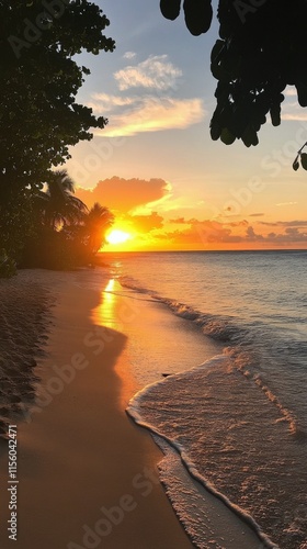 Sunset over calm waves at tropical beach with palm trees along serene shoreline