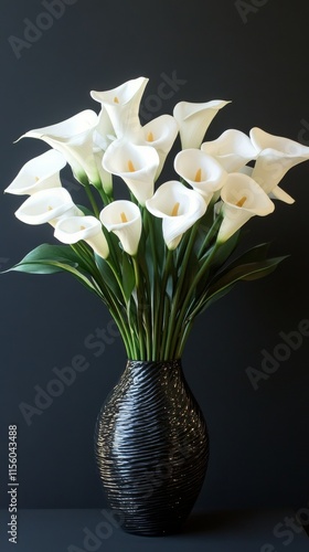 Elegant white calla lilies in a textured black vase against a dark background