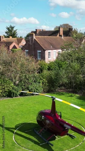 helicopter parked grass luxurious castle property england motion adds touch to scene slow front forward aerial shot luxury country house scenic view aviation 