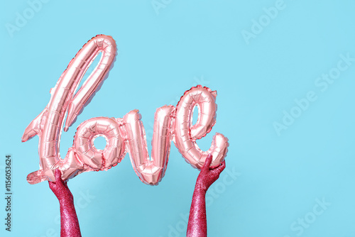 Pink foil love balloon held...