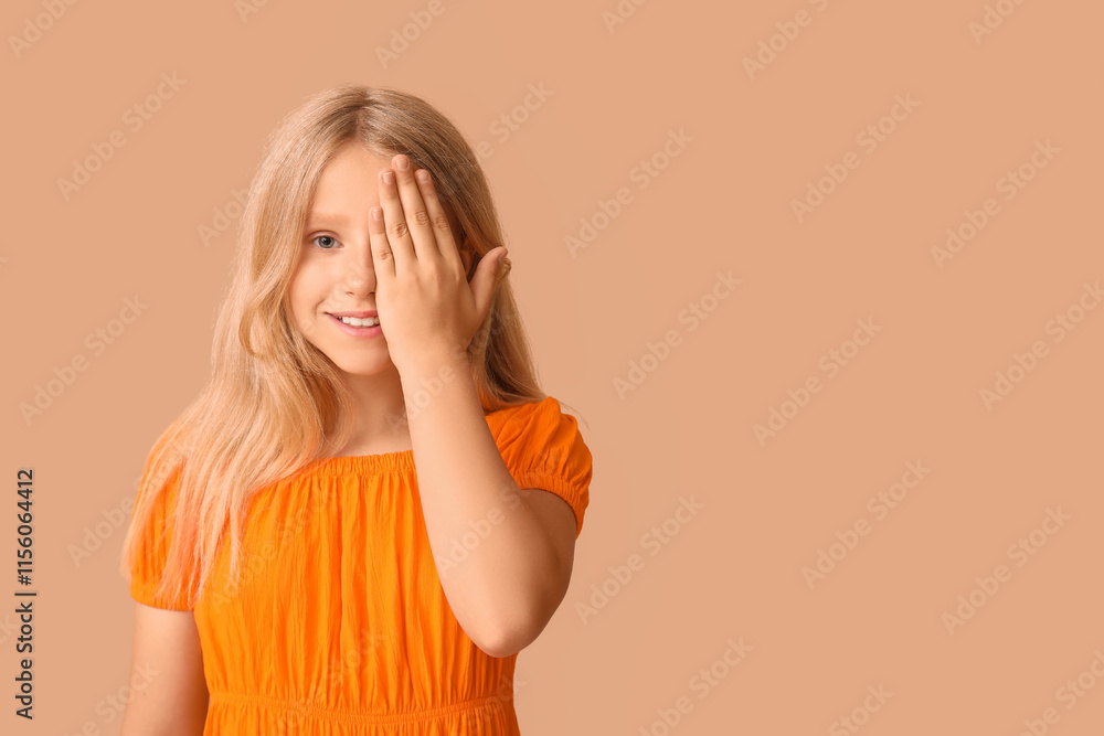 Teenage girl checking her eyesight on beige background. Children's Eye Health and Safety Awareness Month Teenage girl checking her eyesight on beige background. Children's Eye Health and Safety Awareness Month