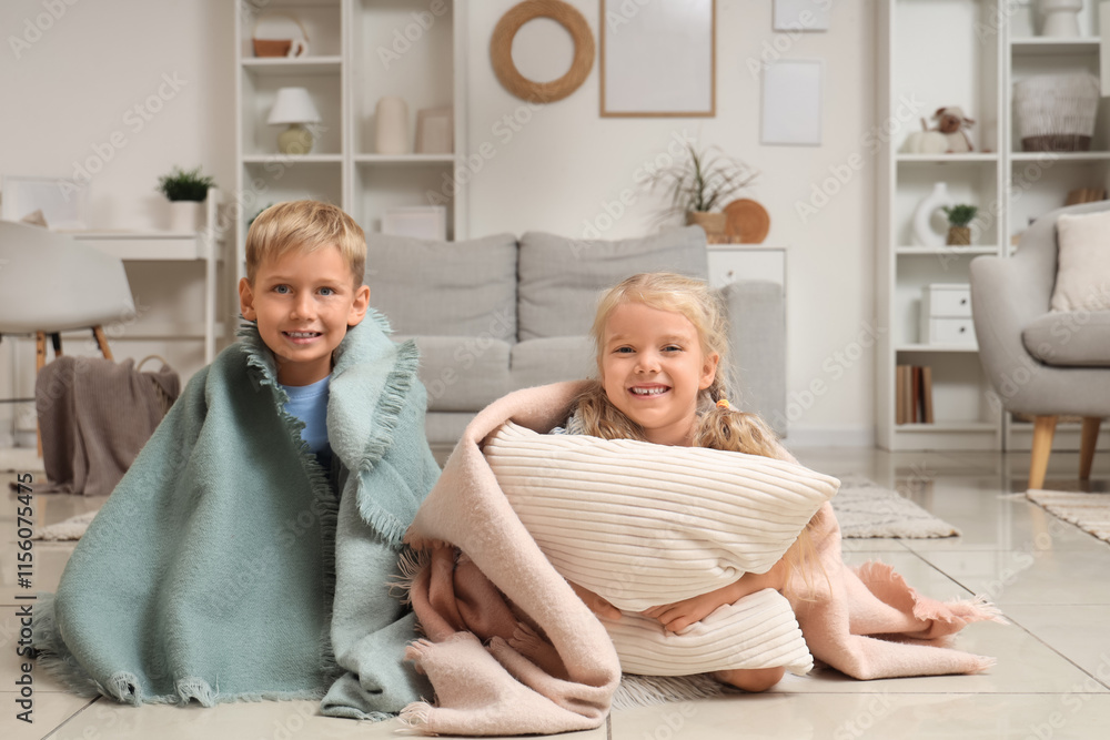 Little kids with plaids sitting on floor at home Little kids with plaids sitting on floor at home