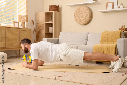 Young man exercising plank ...