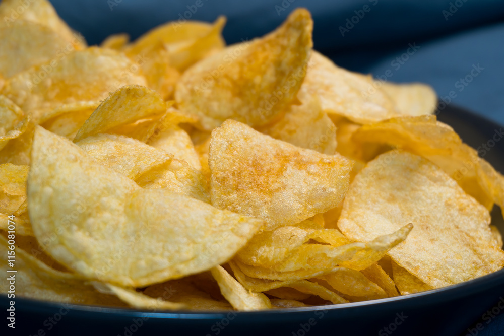 Classic chips in natural lighting: Golden potato chips sparkle in soft lighting, emphasizing their crunchy edges and salty allure. Classic chips in natural lighting: Golden potato chips sparkle in soft lighting, emphasizing their crunchy edges and salty allure.