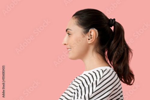 Young woman with hearing ai...