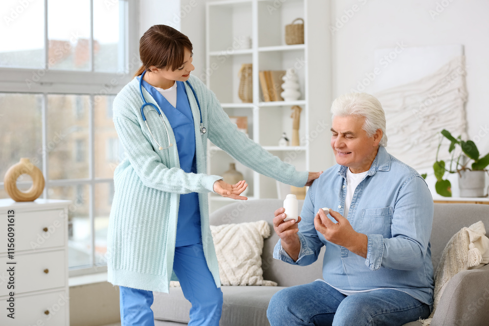 Female doctor and mature man with pills sitting on sofa at home Female doctor and mature man with pills sitting on sofa at home