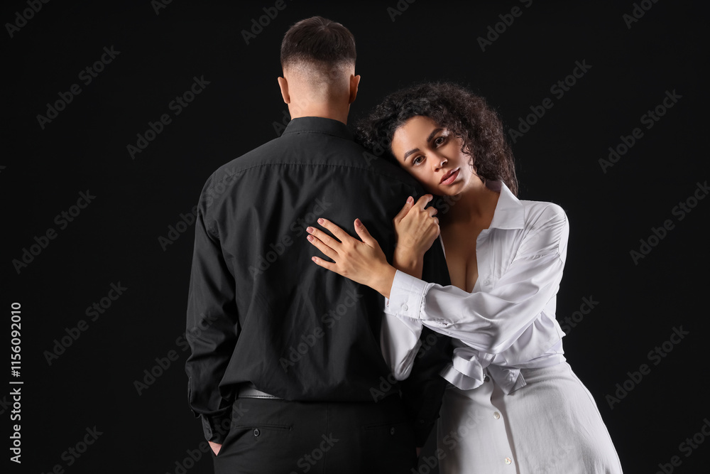 Beautiful young couple hugging on black background. Yin Yang concept Beautiful young couple hugging on black background. Yin Yang concept