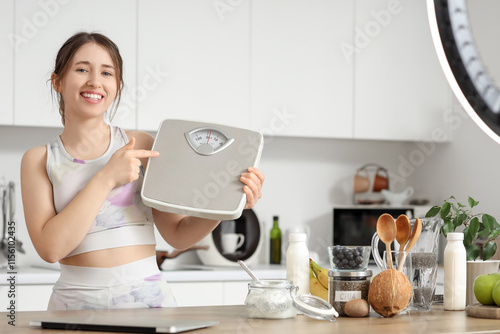 Smiling young woman holding...