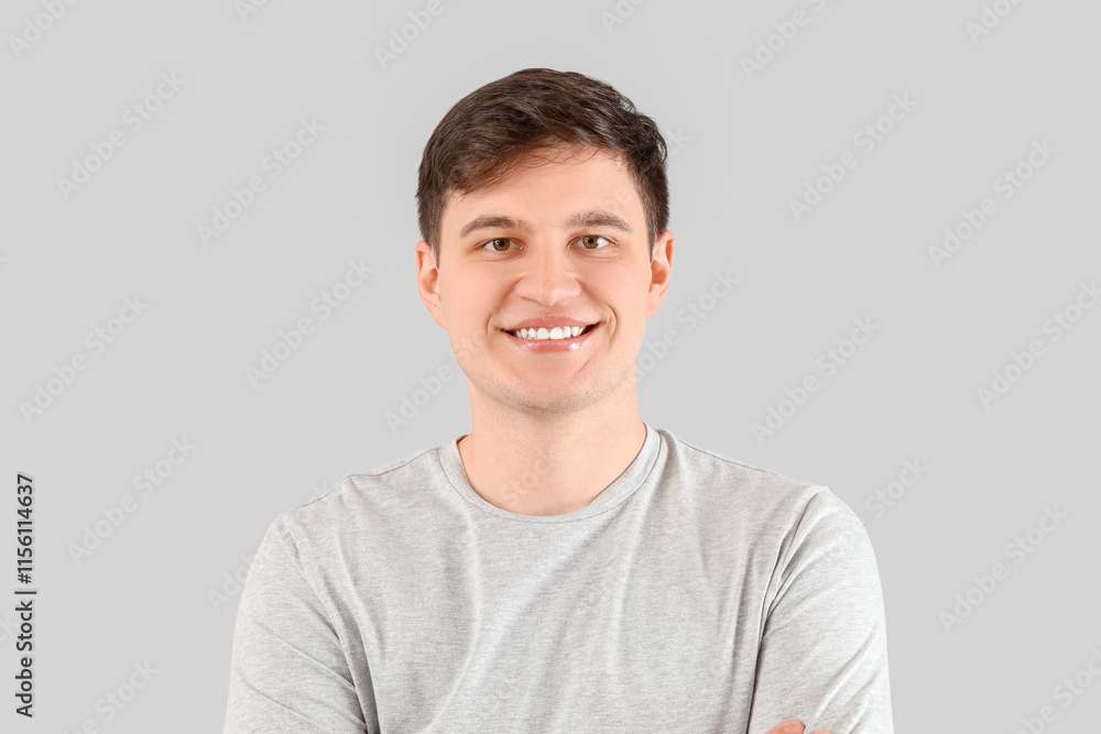 Smiling young man with healthy teeth on light background, closeup Smiling young man with healthy teeth on light background, closeup